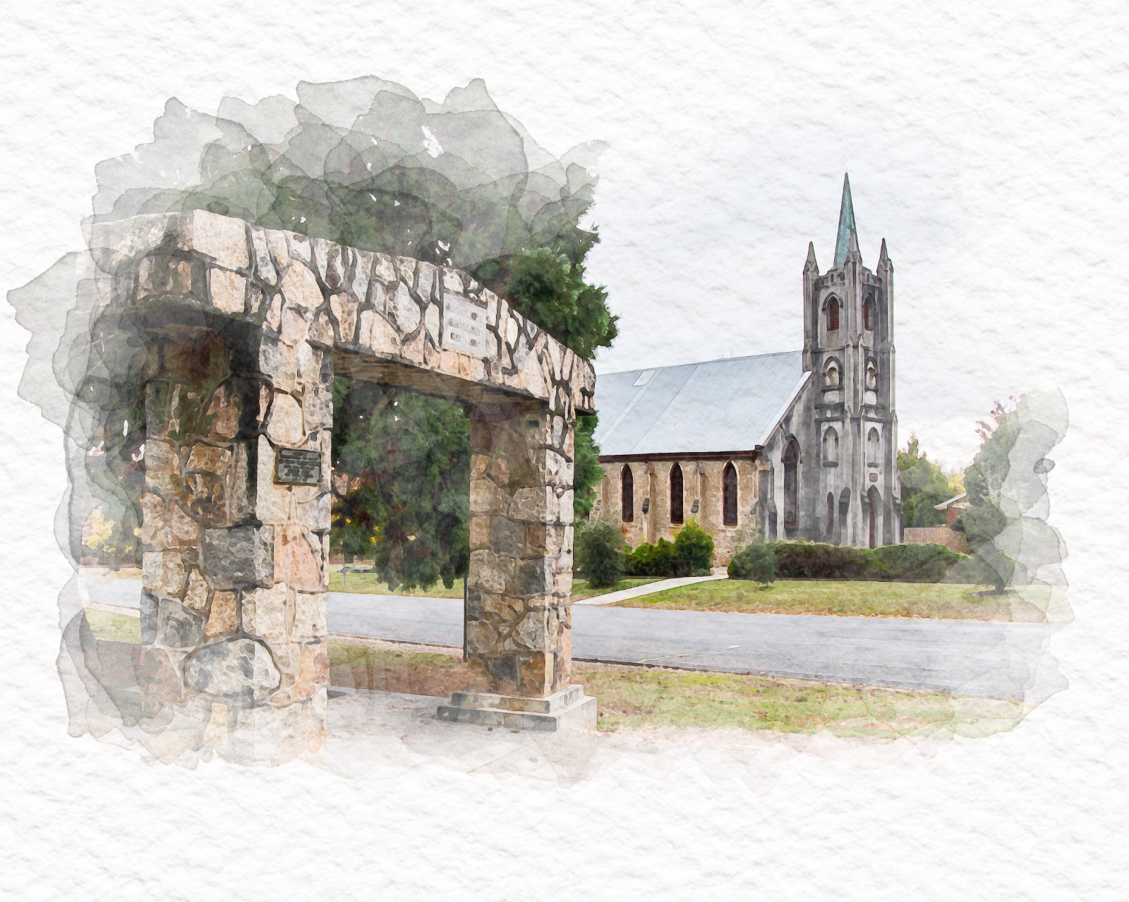A stone archway in the foreground framing a church with a spire in the middle distance.
