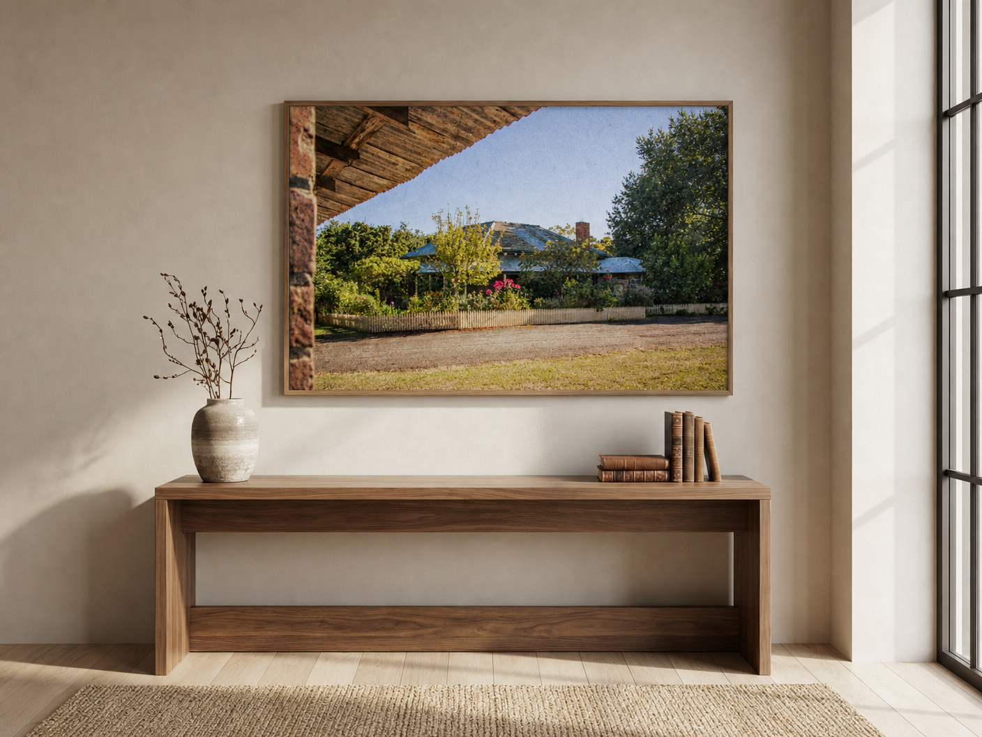 Garden House Behind Picket Fence shown framed on the wall of a light-filled lounge room.